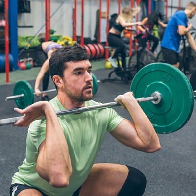 Man Doing Front Squats on Rolled Rubber Gym Flooring