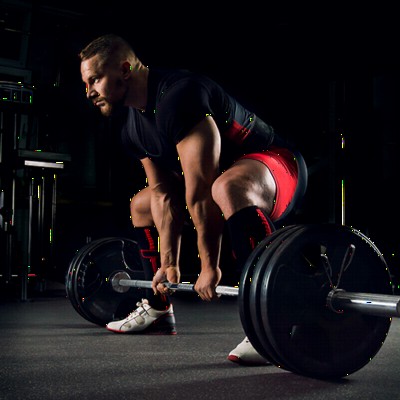 Man deadlifting on 1/2 thick rolled rubber flooring