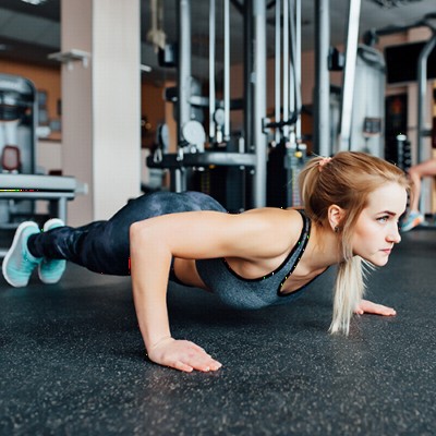 Woman planking on rubber flooring rolls with 10 percent color