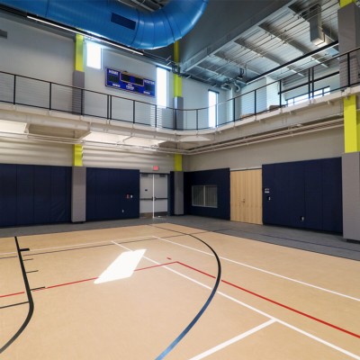 dark blue safety wall pads in gymnasium with ibeam pads