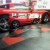Diamond Plate Garage Floor Tiles with Red Car Parked On It