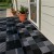 plastic garage tiles installed over wood deck - checker pattern