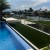 Endless Summer artificial turf next to outdoor pool along waterway with docks in residential ara
