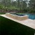 endless summer landscaping turf in backyard next to pool and hot tub area
