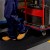 close up of person with cart walking on Firmagrip Industrial Matting in industrial facility