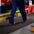 person carrying toolbox while walking on black Flexigrid Industrial Matting 2 x 16.5 ft Roll 
