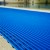 close up of blue Heronrib Wet Area Safety Matting Roll on poolside