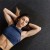 Woman Laying on Rolled Rubber Floor After Workout
