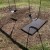 brown rubber swing set mat on dirt underneath swing set