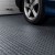 TechFloor Premium Tile with Traction Top garage floor with tire.